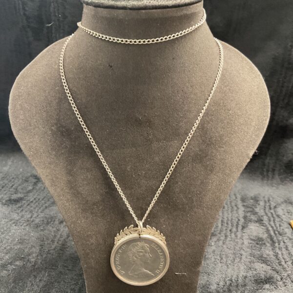 Sterling silver necklace with commemorative coin pendant.