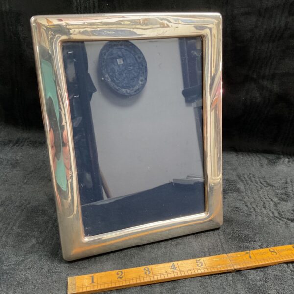 Hallmarked sterling silver photo frame reflecting a room.