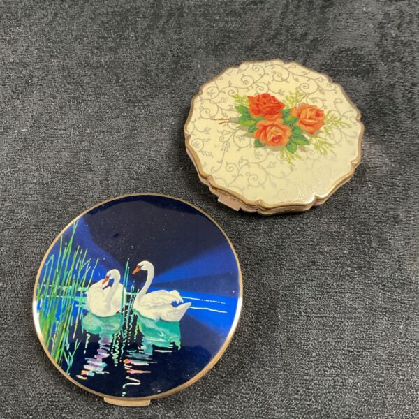 Vintage Stratton compact mirror featuring swans on a blue lake.