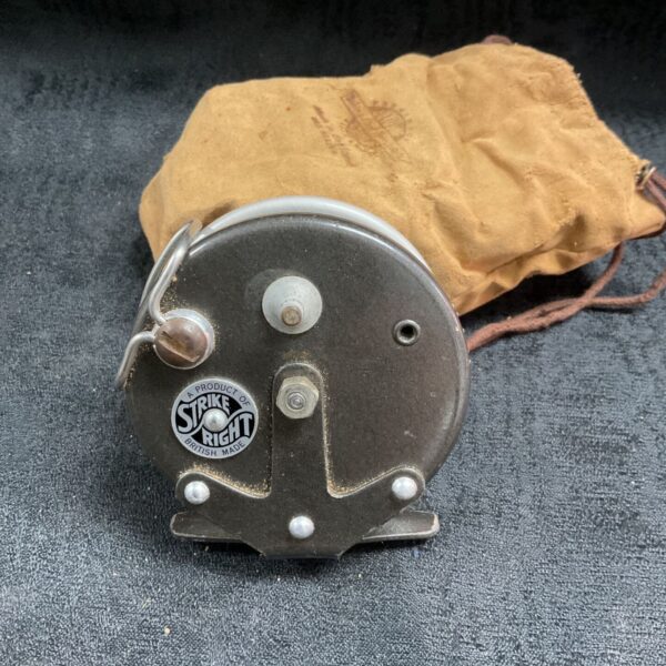 Vintage Strike Right centre pin reel with original bag, showing front view.