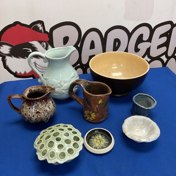 Studio pottery collection featuring a Gisela Graham fish jug and bowls.