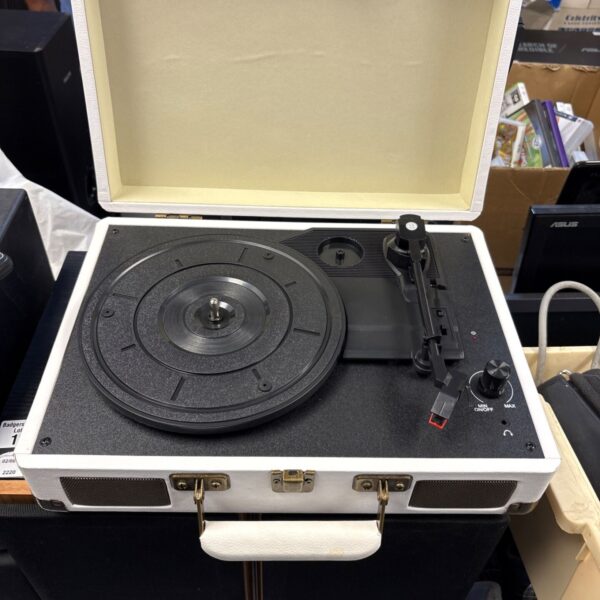 Vintage suitcase turntable with open lid and record player.