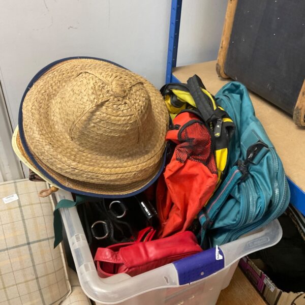 Mixed lot of summer hats and clothing items.
