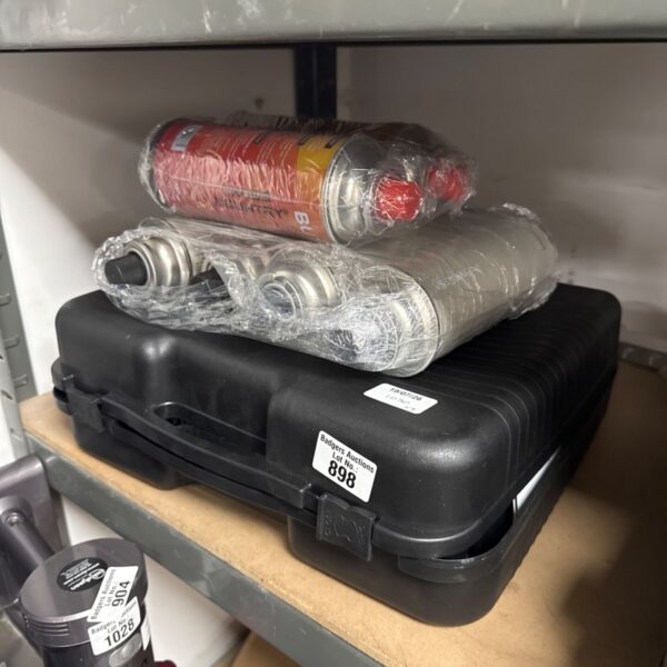 Summit portable butane cooker with spare canisters visible.