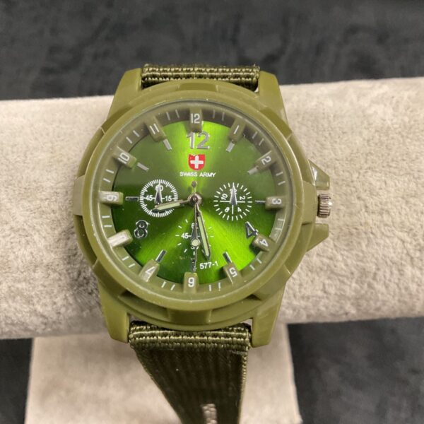 Vintage Swiss Army quartz watch with green dial and canvas strap.