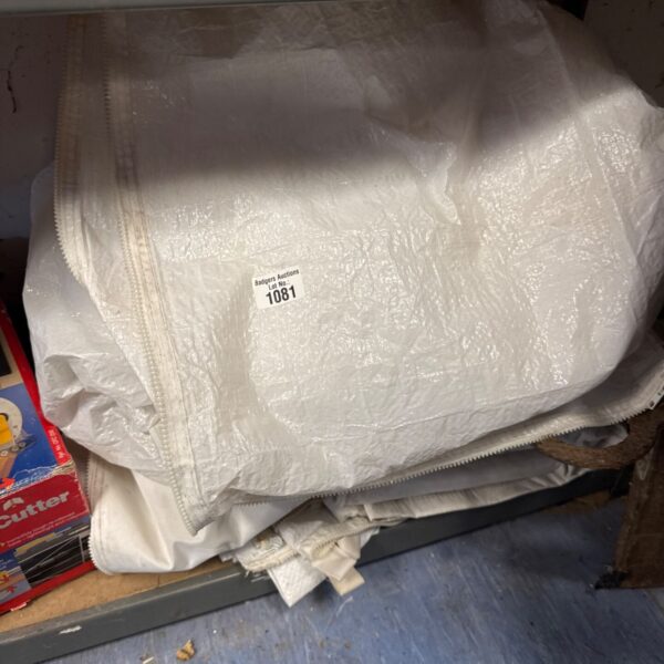 Stack of heavy-duty tarpaulin sheets with zip connectors for waterproof cover.
