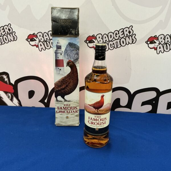 Bottle of The Famous Grouse Scotch whiskey with box.