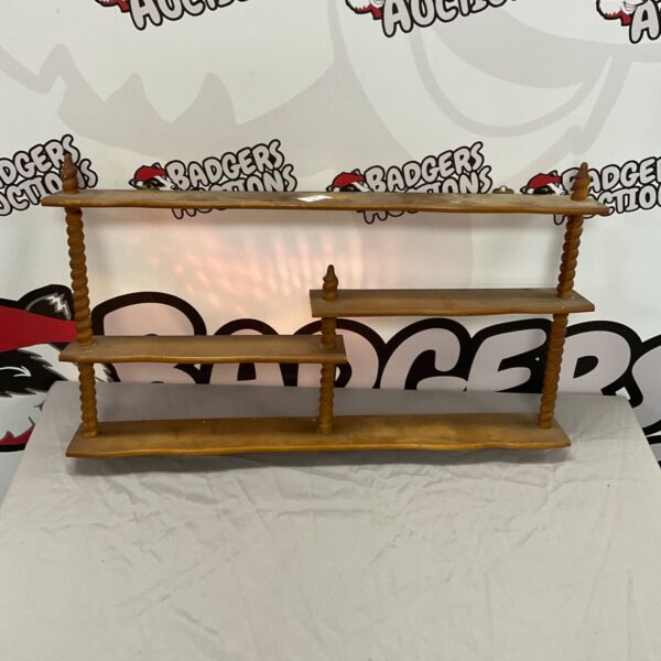 Vintage three tier wooden shelf for collectibles and display.