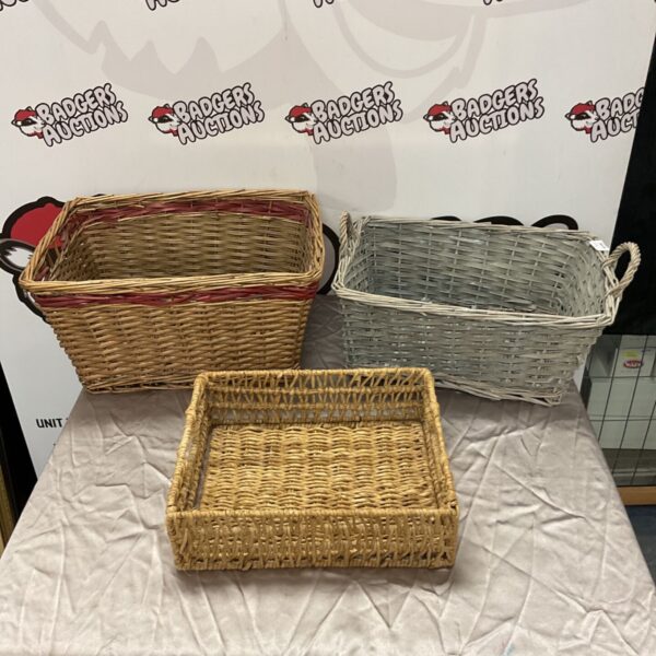 Three vintage wicker baskets for storage and farmhouse decor.