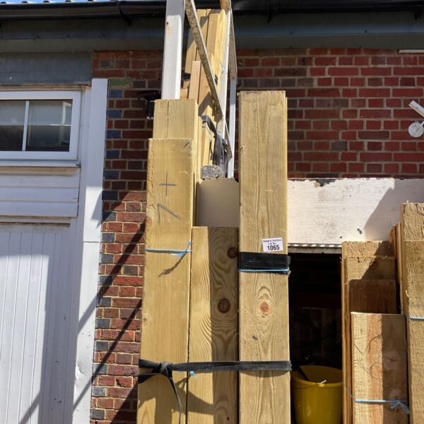 Three bundles of 7ft timber leaning against a wall.