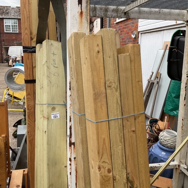 Three bundles of 5’6” timber stacked outdoors, ready for a project.