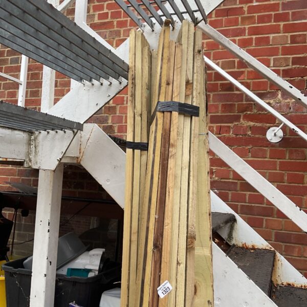 Three bundles of 8ft timber stored outdoors, ready for DIY projects.