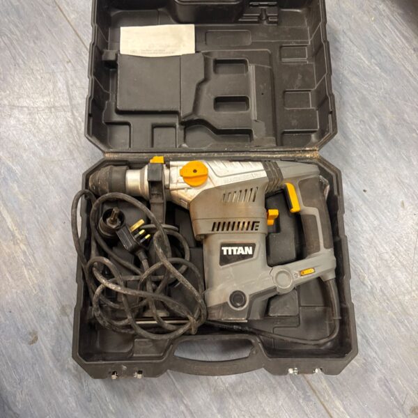 Titan SDS drill in its original carry case, showing signs of use.
