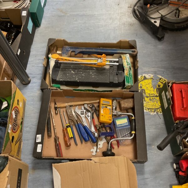 Assorted hand tools including wrenches and screwdrivers in a box.
