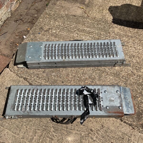 Metal trailer access ramp with textured surface for loading.