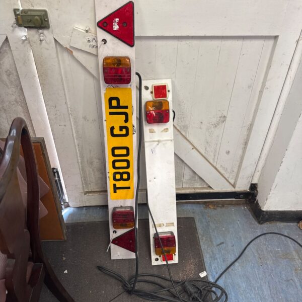 Used trailer light boards with red and white lights for towing.