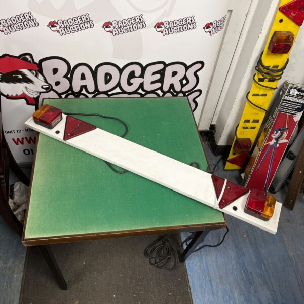 White trailer lighting board with rear lights and reflectors.