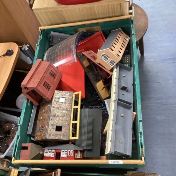 Crate of vintage train set buildings for model railways.