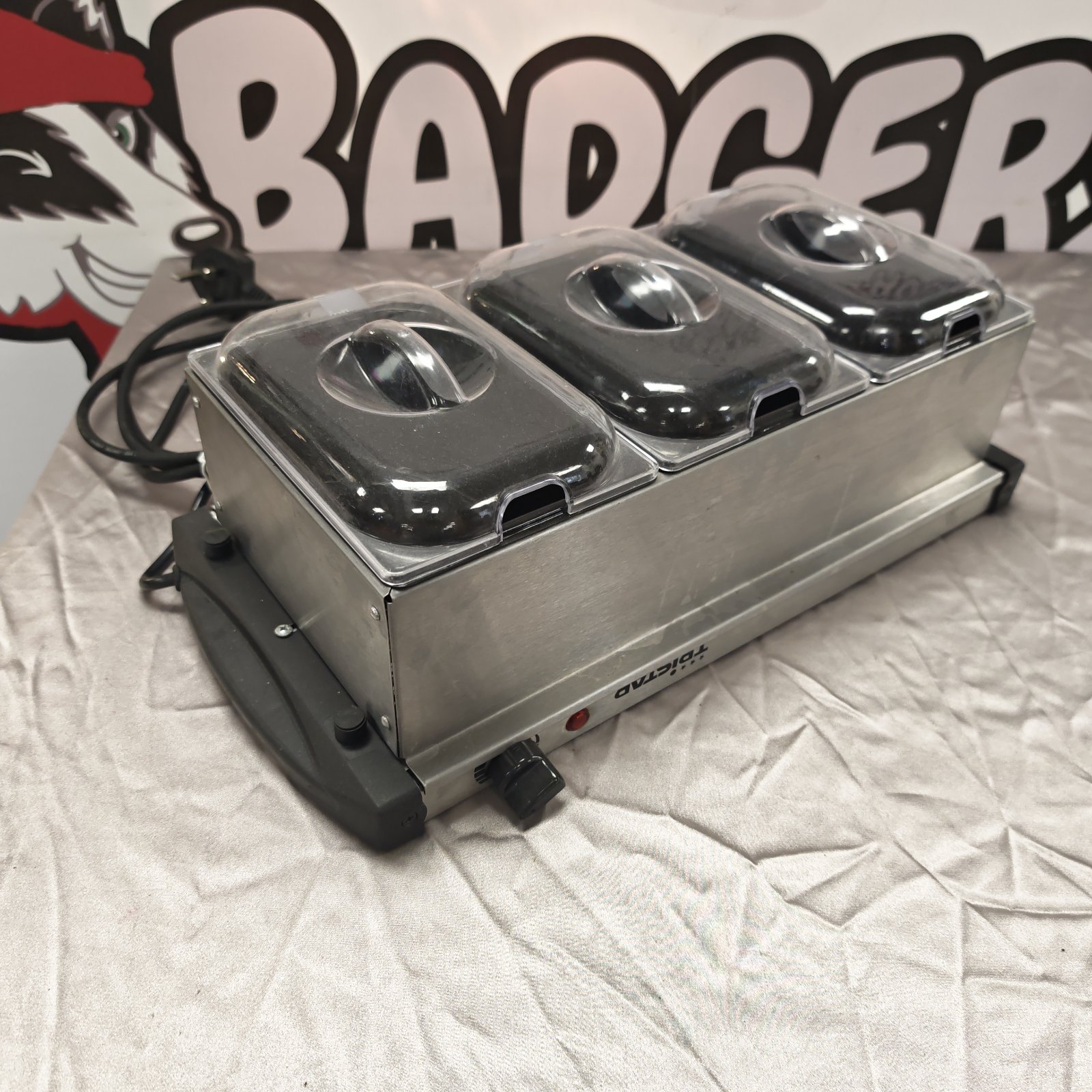 Stainless steel TriStar food warmer with three trays for buffet service.