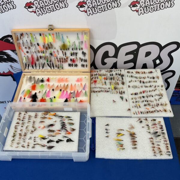 Collection of colourful trout fishing flies in boxes.