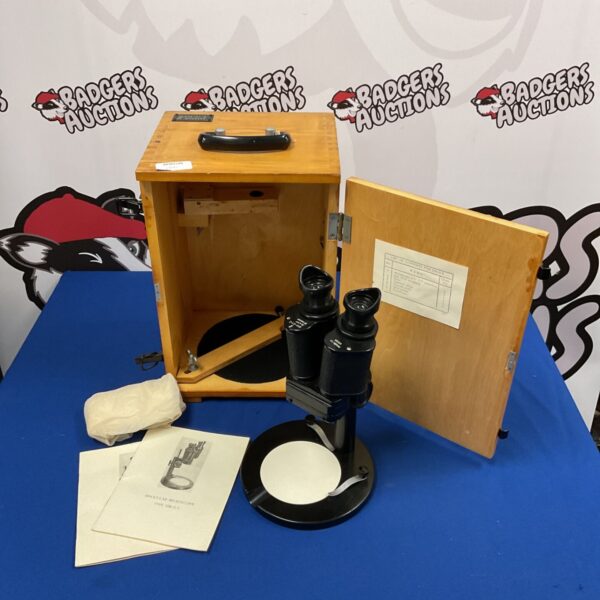 Vintage USSR binocular microscope in a wooden case, showing the complete set.