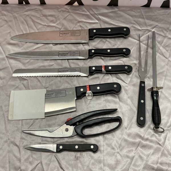 Vintage Vachmayr kitchen knife set with stainless steel blades and black handles.