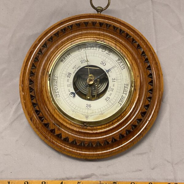Antique Victorian brass barometer with weather prediction dial.