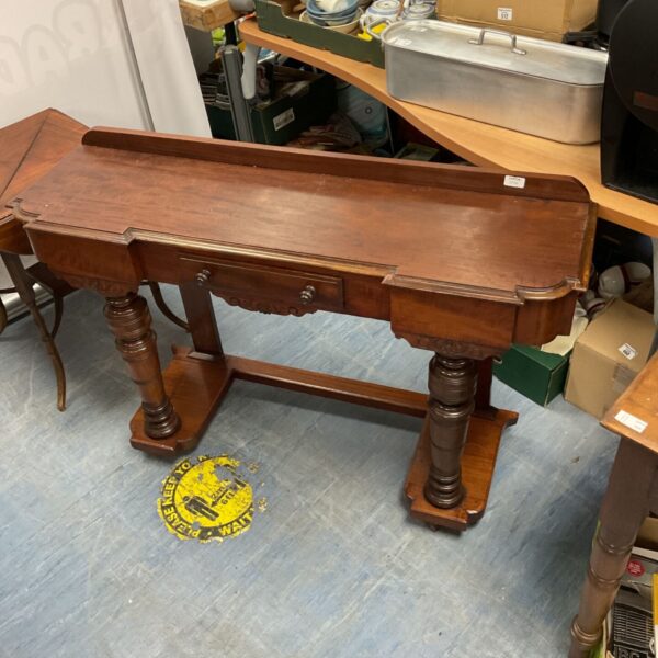 Antique Victorian mahogany console table with drawer and carved legs.