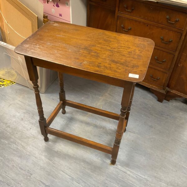 Antique mahogany occasional table with tripod legs.