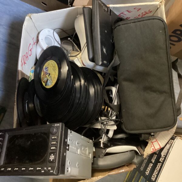 Vintage audio lot featuring a car stereo and vinyl records.