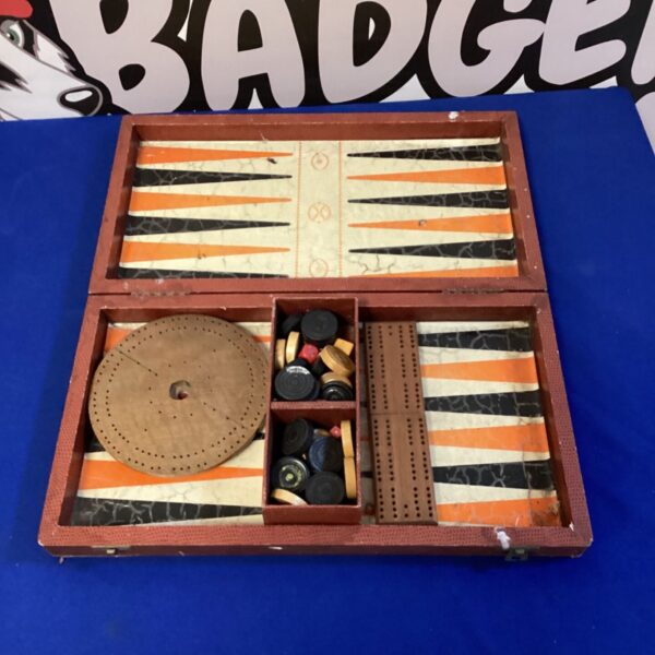 Vintage backgammon and cribbage set with wooden board and pieces.