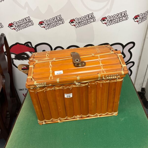 Vintage bamboo picnic case with leather strap, side view.