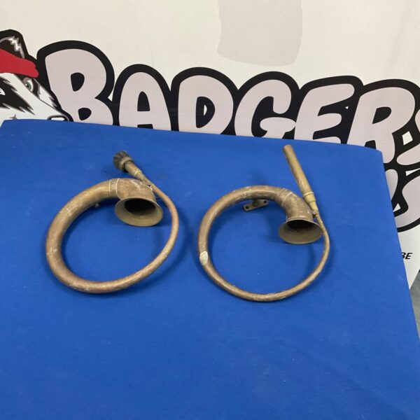 Pair of vintage brass car horns, classic automotive accessories.