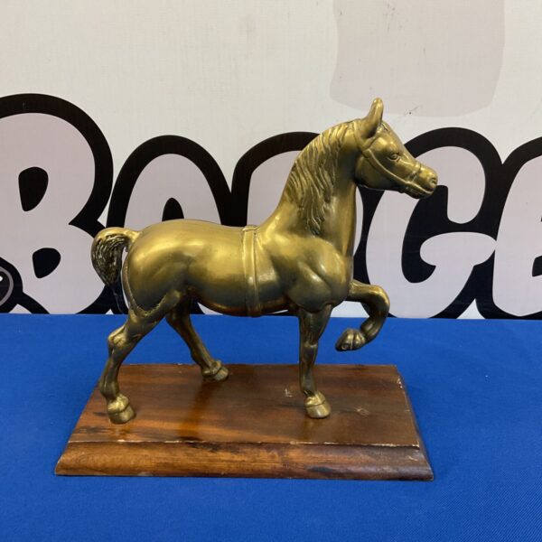 Vintage brass horse sculpture on wooden base, detailed animal figurine.