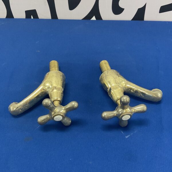 Pair of vintage brass taps with cross handles.