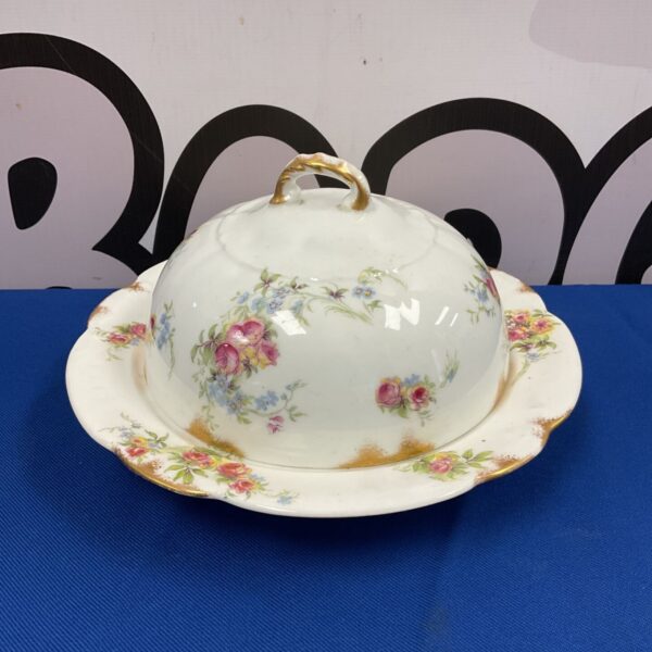 Vintage C T M & Sons butter dish with a delicate rose pattern.
