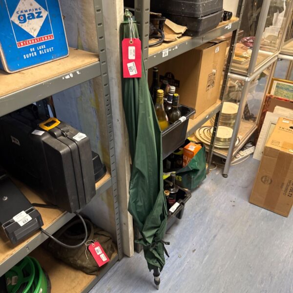 Vintage green camping brolly with extendable pole, showing signs of wear.
