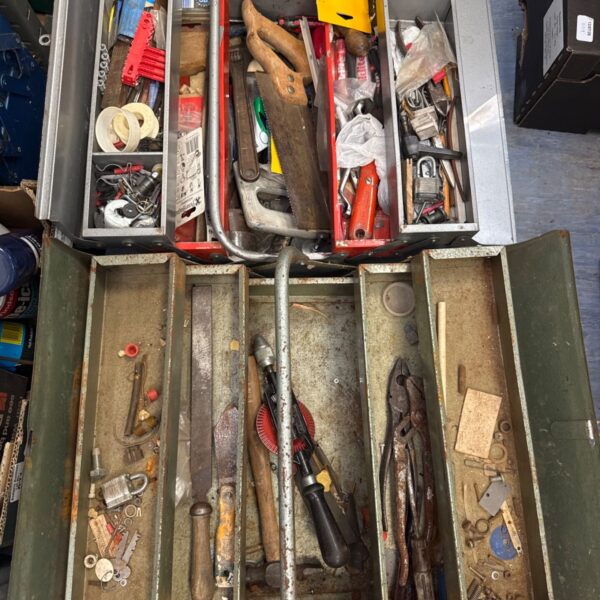 Vintage cantilever toolboxes filled with tools for workshop storage.