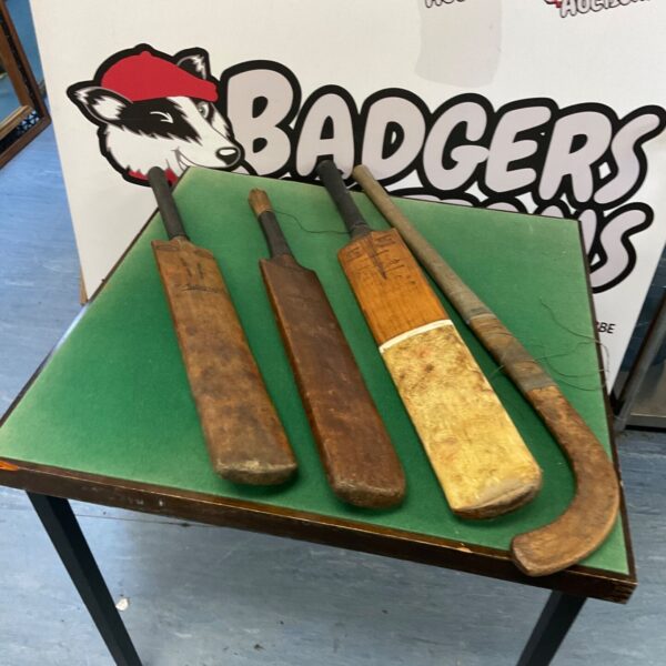 Vintage cricket bats and hockey stick lot for collectors.