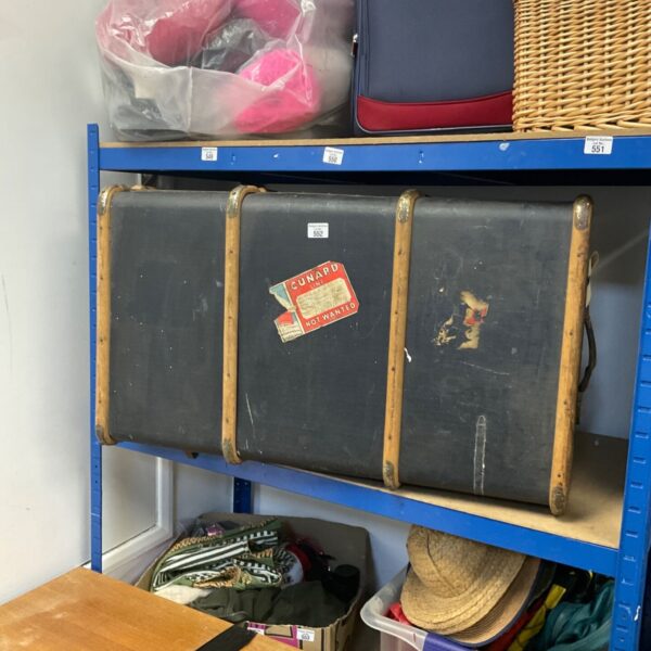 Large vintage Cunard trunk with canvas covering and travel sticker.