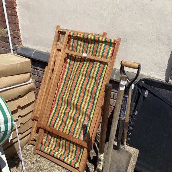 Colourful vintage deck chair with striped canvas and wooden frame.