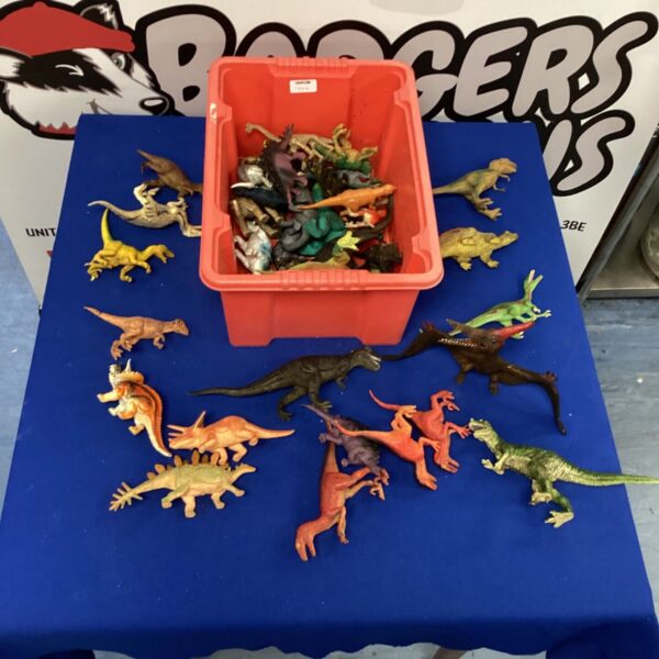 Box of vintage plastic dinosaur toys for collectors.