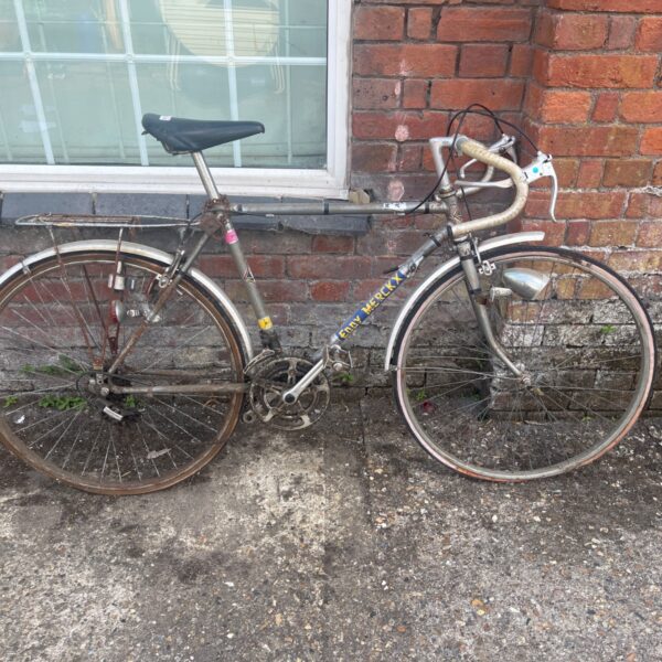 Vintage Eddy Merckx road bicycle needing restoration.
