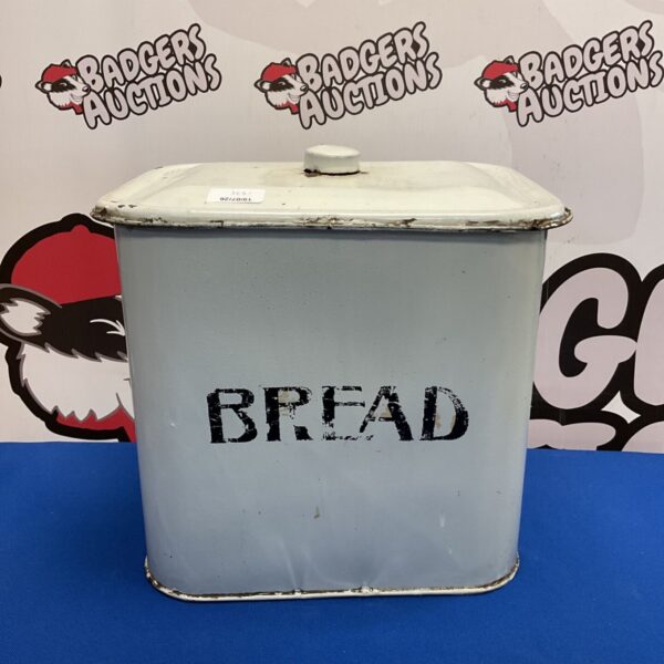 Vintage enamel bread bin with hinged lid, classic kitchen storage.