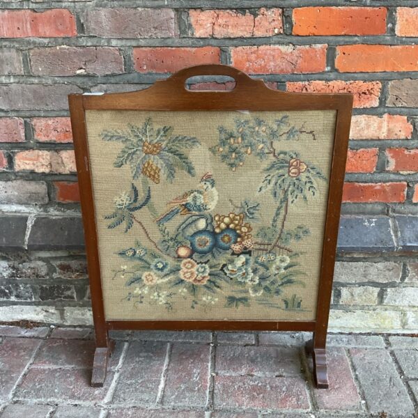 Vintage fire guard with a colourful bird of paradise tapestry and oak frame.