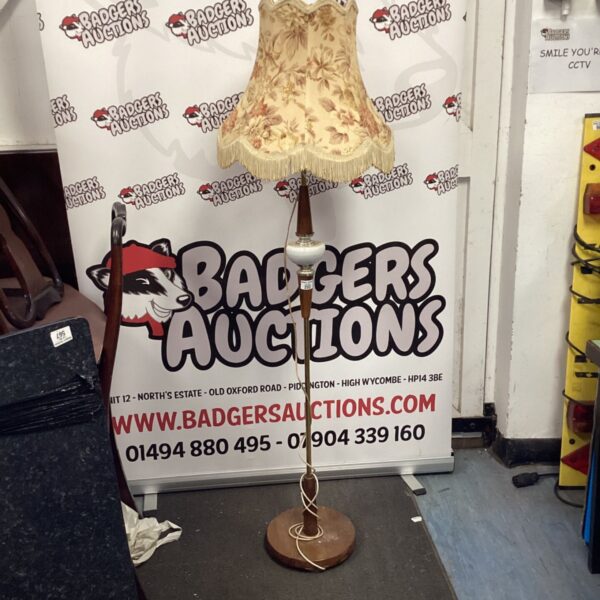 Vintage floor lamp with a cream shade and tiered base.