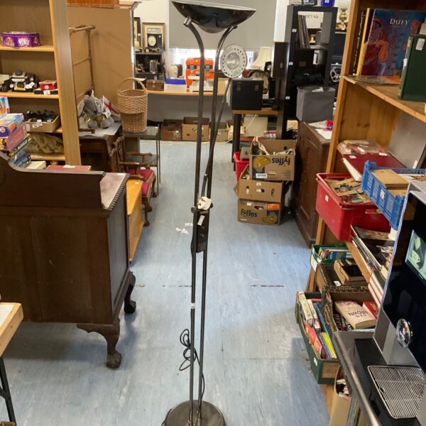 Vintage chrome floor lamp with adjustable shade for reading.