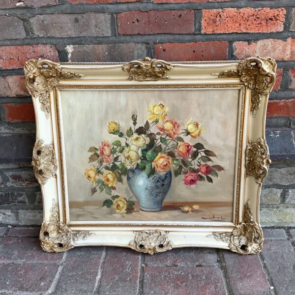 Vintage floral oil painting of roses in a gilded frame.