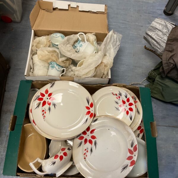 Vintage floral tea set with cups, saucers, and plates in a box.