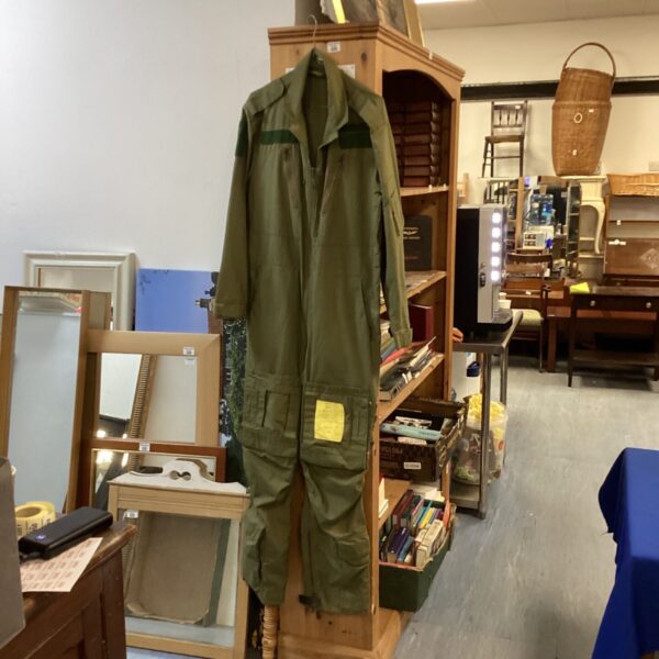 Vintage green flying suit with accompanying Jeppeson airway manual.